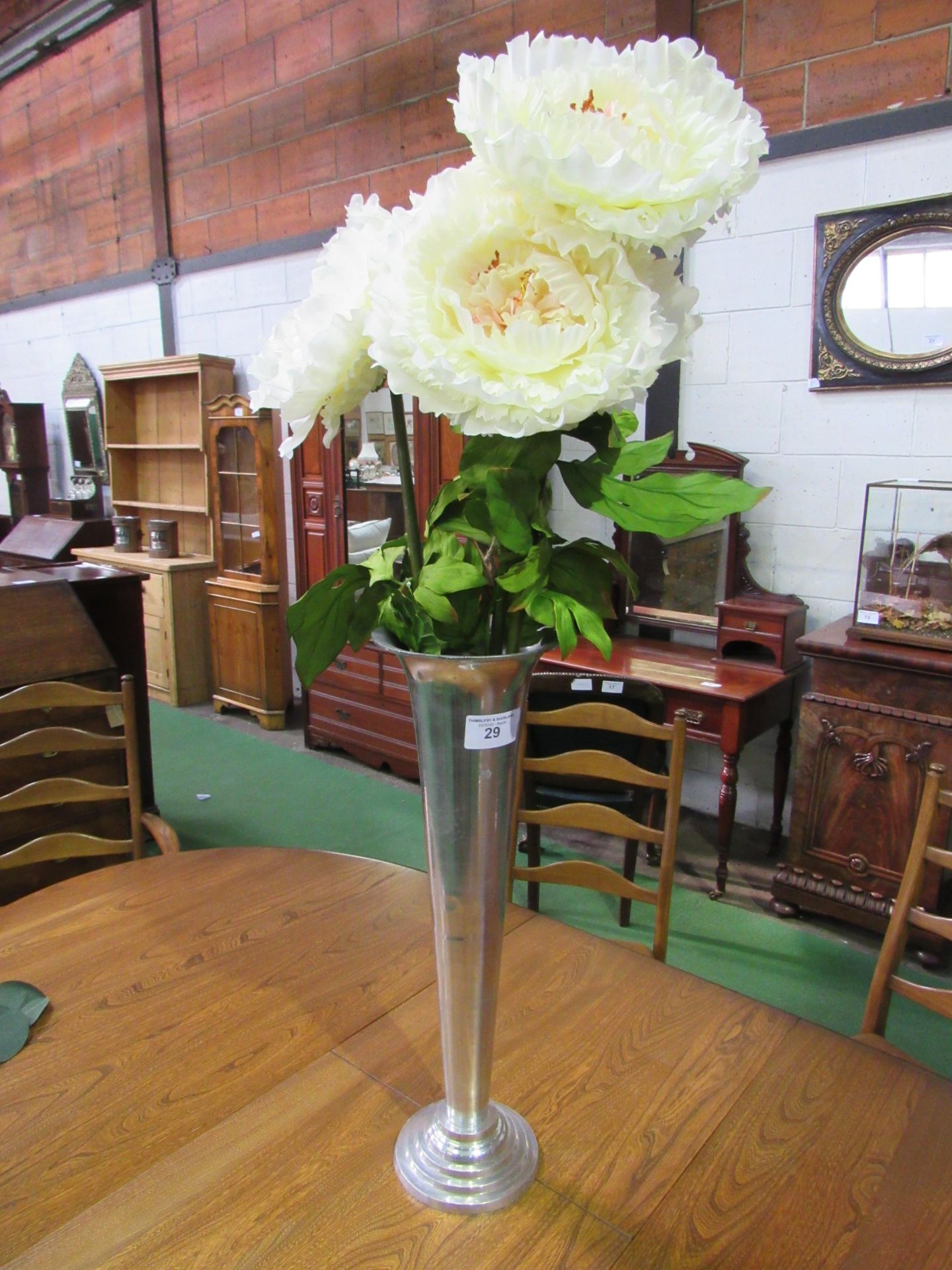 Tall white metal vase complete with 3 artificial peonies. Height 66cms. Estimate £20-30.