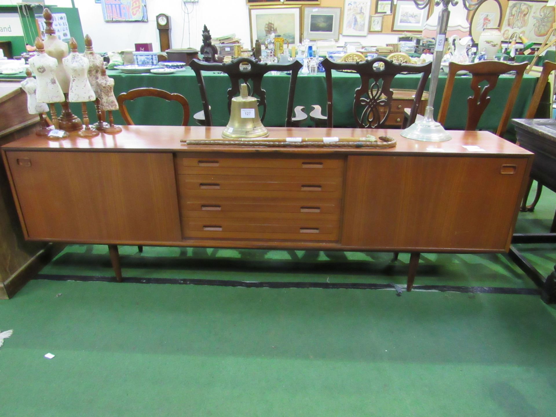 Teak sideboard with 4 centre drawers flanked by cupboards, 222 x 43 x 72cms. Estimate £80-120.