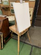 New artist's easel together with pastels and brushes. Estimate £35-50.