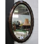 Oval shaped bevelled edge mirror in tortoise shell effect frame. Estimate £20-30