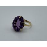 Yellow metal ring set with large amethyst, 17mm x 12mm, size H, weight 3.7gm. Estimate £200-220.