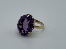 Yellow metal ring set with large amethyst, 17mm x 12mm, size H, weight 3.7gm. Estimate £200-220.