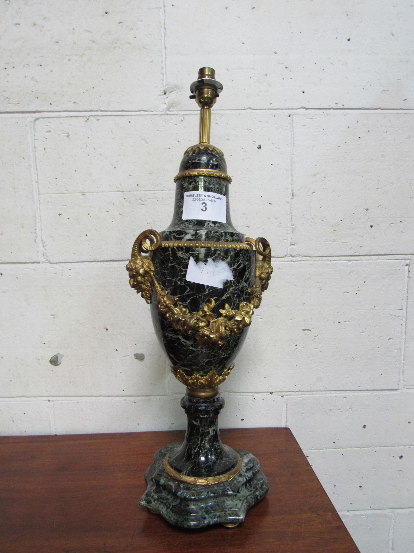 Marble urn shaped lamp with ornate decorations as found. Height 64cm. Estimate £20-40.