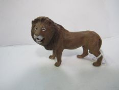 Cold painted bronze lion figure with Bergman jar mark underneath. Estimate £30-50.