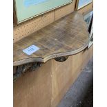 Ornate large rococo gilt wood wall bracket with serpentine shelf. Estimate £40-60.