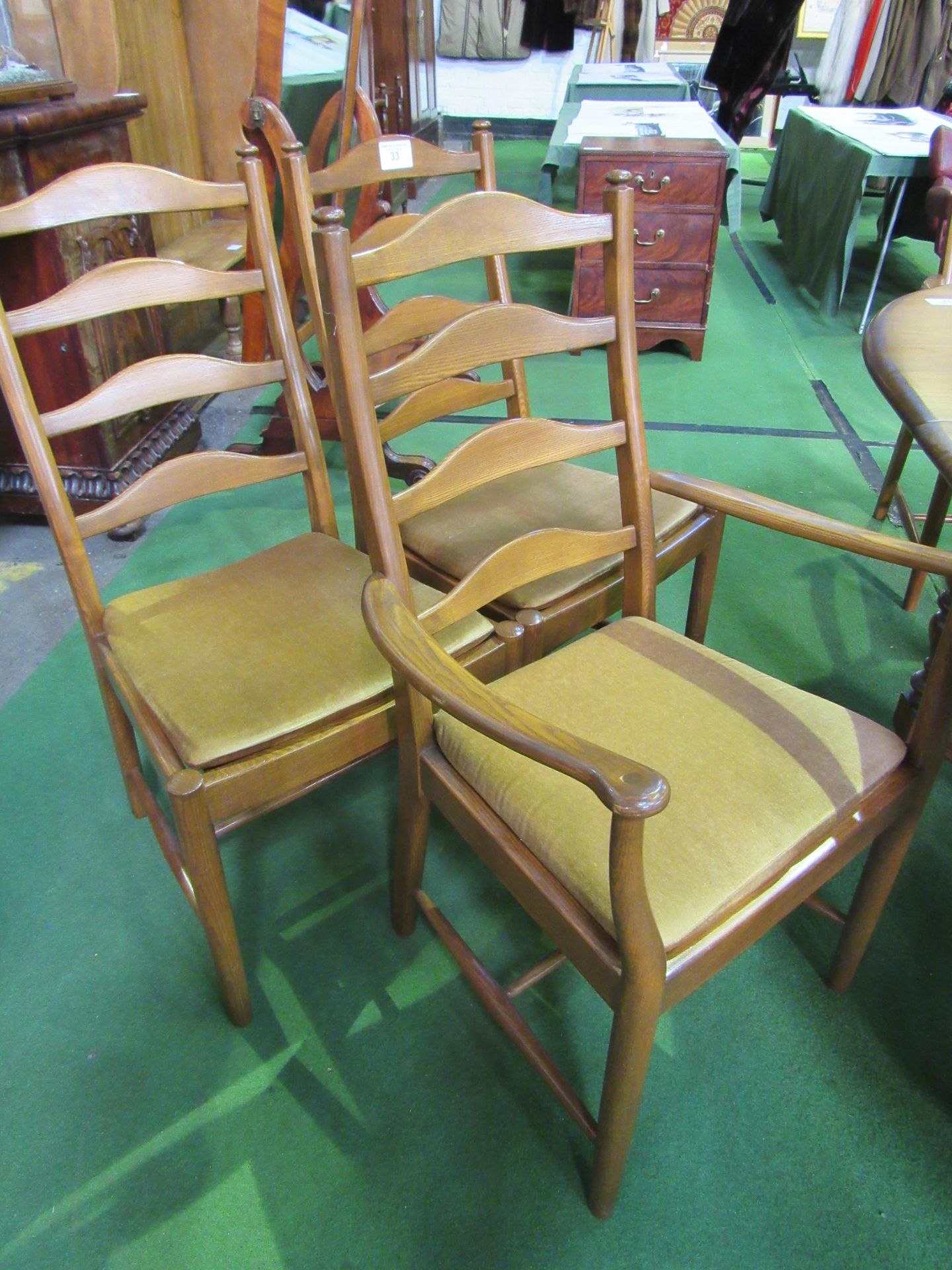 2 + 4 Ercol ladder back dining chairs to suit lot 32. Estimate £120-150.