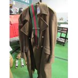 Military overcoat together with a belt. Estimate £30-50.