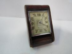 1930's Cartier ""Huit Jours"" travelling alarm clock in leather case. Estimate £100-150.