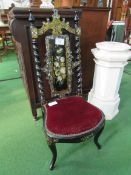 Ebonised and mother of pearl inlaid low chair. Estimate £20-30.