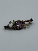 9ct gold seed pearl and purple stone brooch. Estimate £20-30.