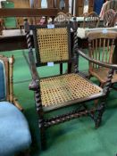 Oak armchair with cane back and seat. Estimate £20-30.