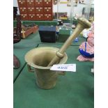Brass pestle and mortar. Height 13cms, Diameter 14.5cms. Length of pestle 26cms. Estimate £10-20.