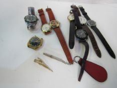 8 various wrist watches and tie clip and a silver cased propelling pencil. Estimate £20-40.