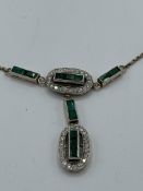 Diamond and emerald necklace on a 9ct gold chain. Estimate £850-900.
