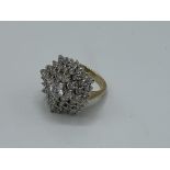 9ct gold ring set with large cluster of white stones, size T, weight 11.1gms. Estimate £300-320.