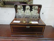 Rosewood Tantalus of 3 cut glass decanters with front compartment and secret drawer. Estimate £30-