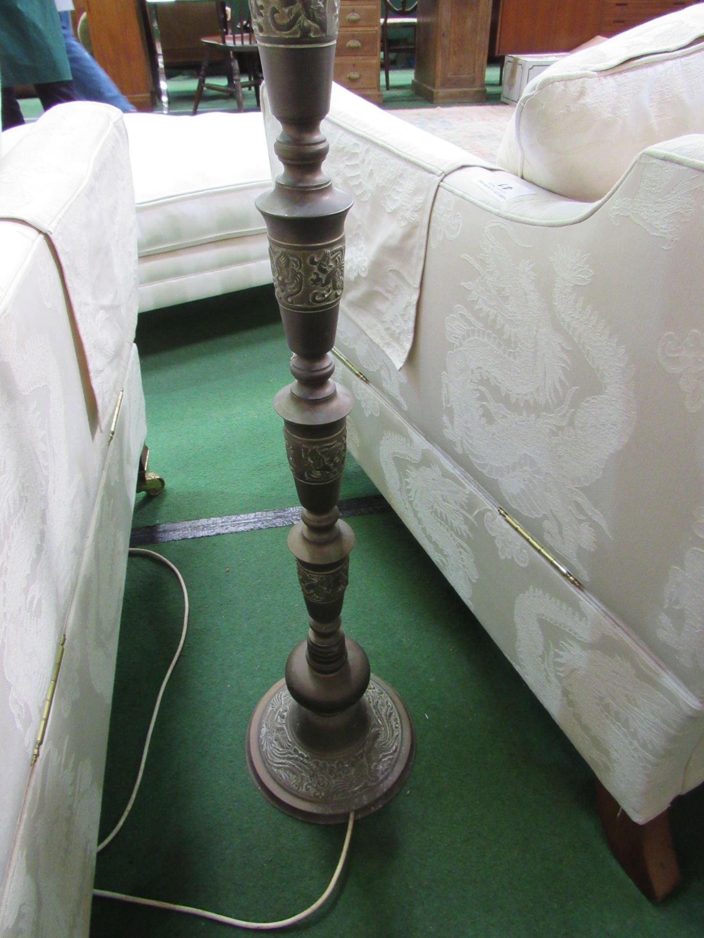 Brass decorated lamp standard and shade. Estimate £10-20.