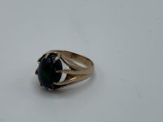 Yellow metal ring set with black opal, size L 1/2, weight 4.1gms. Estimate £650-680.