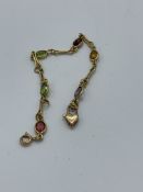 Yellow metal bracelet with coloured stones, length 18cms, weight 7.5gms. Estimate £30-50.