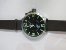 An oversize wrist watch with new strap and battery. Estimate £15-20.