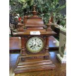 Oak case mantel clock with finial decoration. Height 52cms Estimate £40-60.