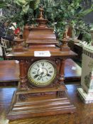 Oak case mantel clock with finial decoration. Height 52cms Estimate £40-60.