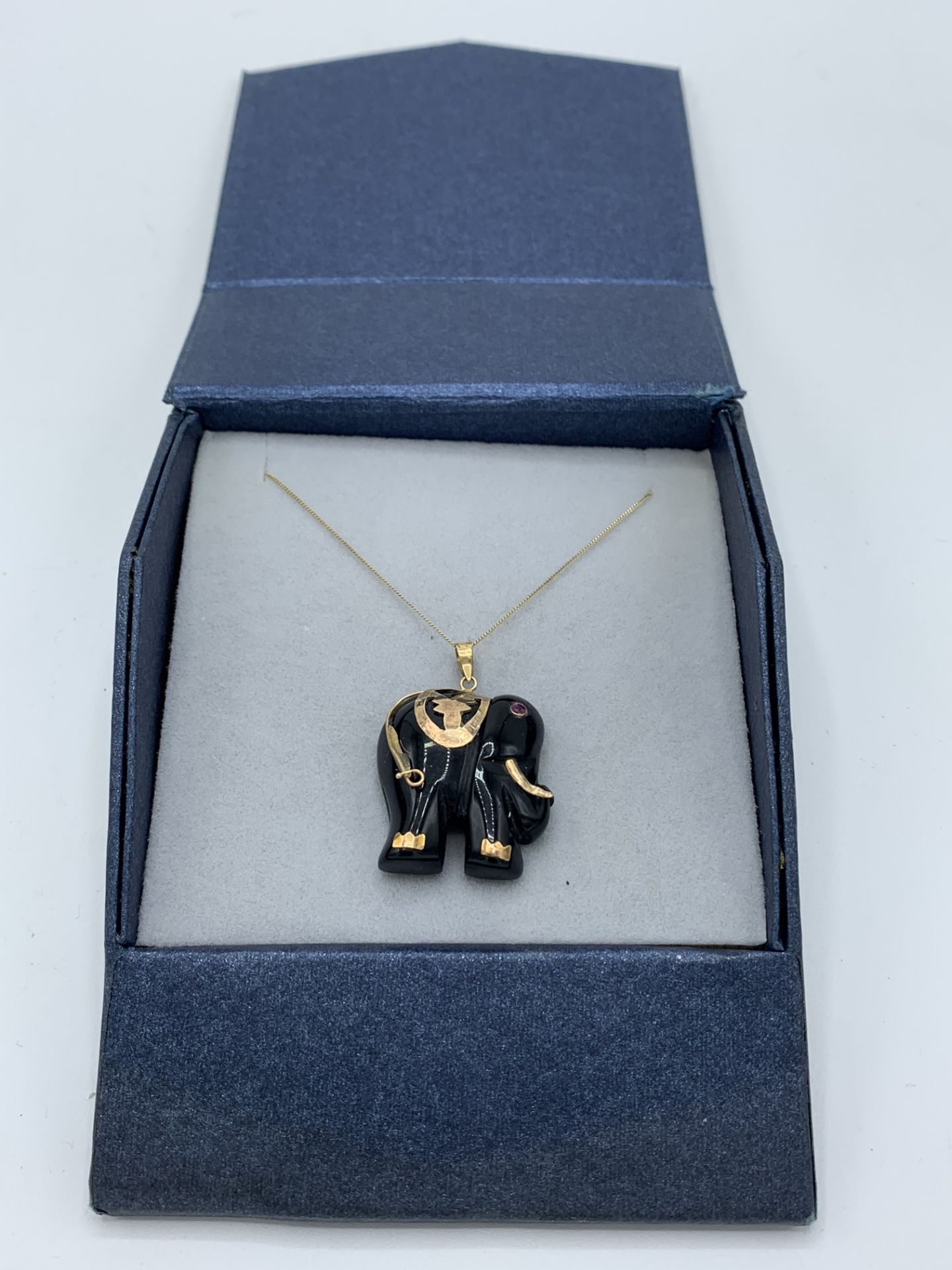 9ct gold onyx & ruby elephant necklace, length 23cms. Estimate £30-50