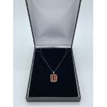 9ct white gold necklace with orange sapphire pendant, length 24cms. wt 4.6gms Estimate £20-40