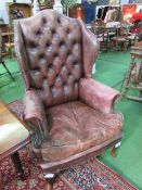 Hand dyed antique leather Regency-style button back wing armchair. Estimate £100-120.