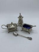 Sterling silver cruet set together with sterling silver decorative spoon. Estimate £20-30.