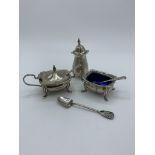 Sterling silver cruet set together with sterling silver decorative spoon. Estimate £20-30.