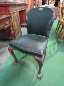 Green leather upholstered chair on ball and claw feet at front. Estimate £30-50.