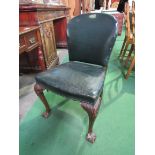 Green leather upholstered chair on ball and claw feet at front. Estimate £30-50.