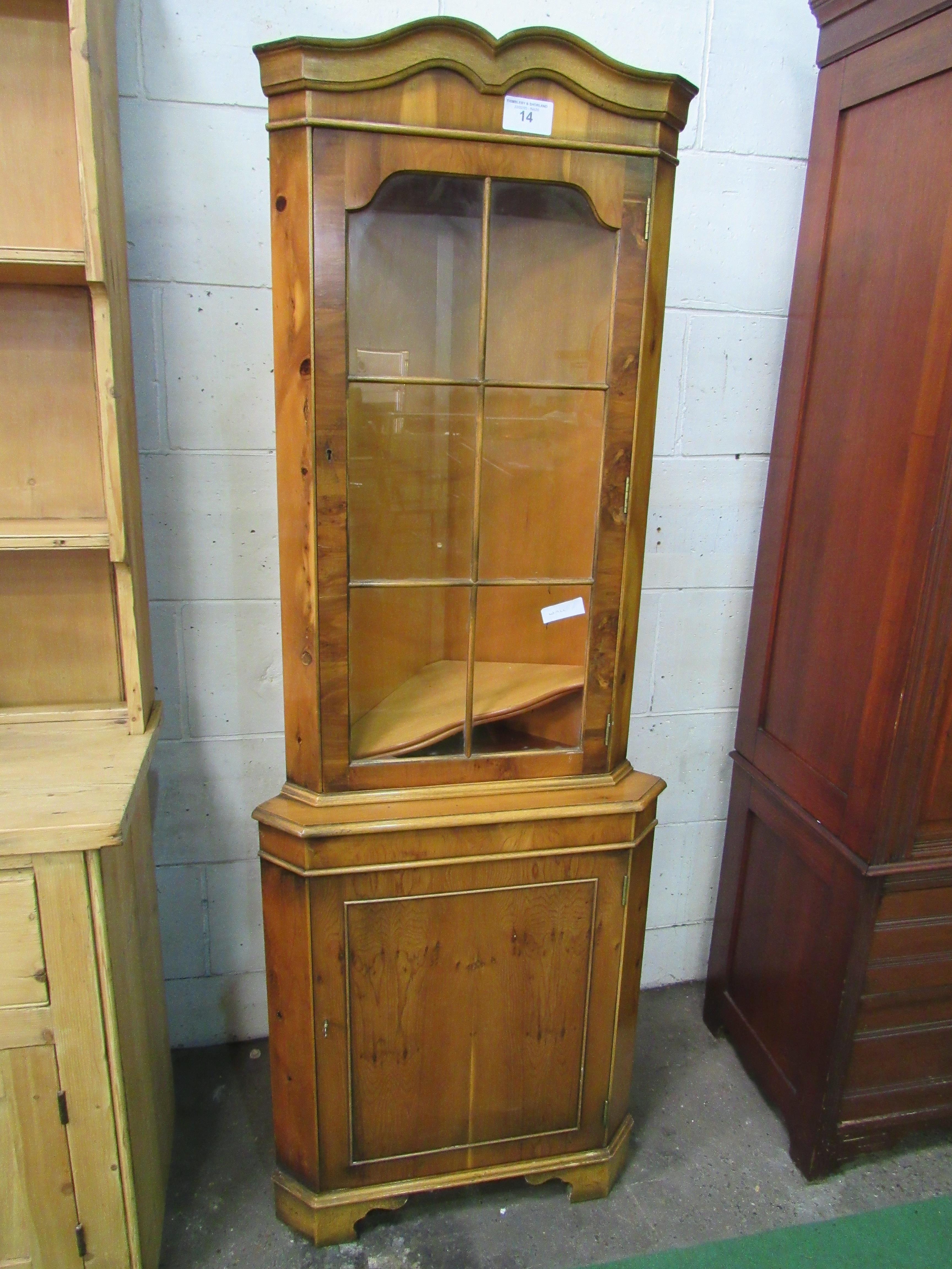 Yew wood corner cabinet with glass door above cupboard. 63 x 41 x 183cms. Estimate £20-30.