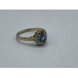 9ct gold ring sent with oval blue stone surrounded with diamonds, size Q, weight 3.0gms. Estimate £