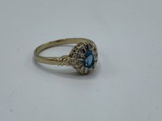 9ct gold ring sent with oval blue stone surrounded with diamonds, size Q, weight 3.0gms. Estimate £