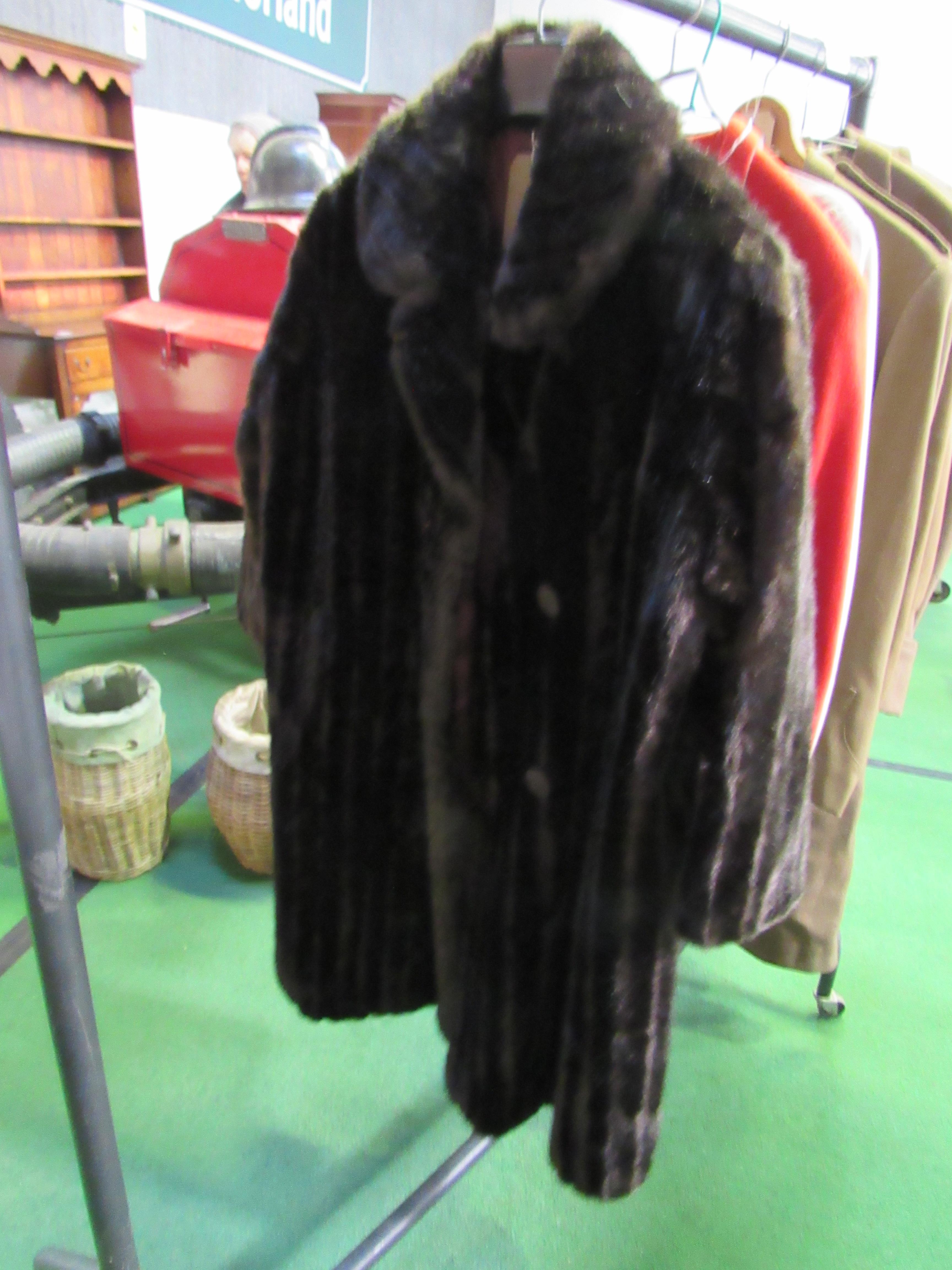 Dynathink simulated long dark brown fur coat. Estimate 20-40.