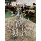 Large white painted metal chandelier. Height 117cms. Diameter 134cms. Estimate £50-70.