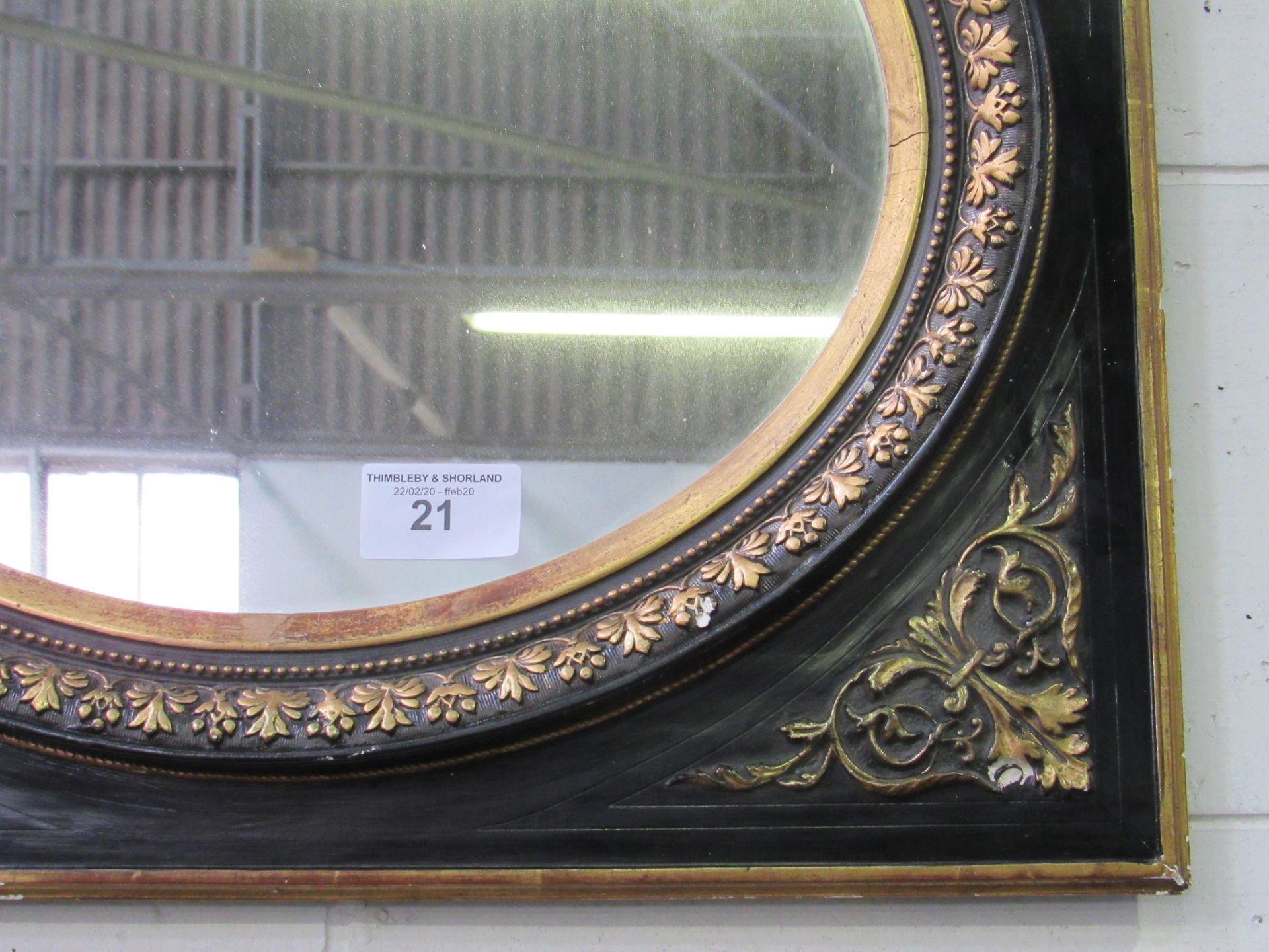 Ebonised oval mirror with gold foliage in a square frame with gold spandrels. Estimate £50-60. - Image 2 of 2