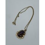 Black opal pendant on a yellow metal chain. Estimate £600-650.