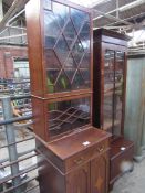 Glass fronted display cabinet on cupboard base.