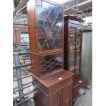 Glass fronted display cabinet on cupboard base.