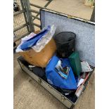 Silver coloured trunk containing miscellaneous clothing.