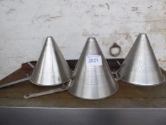 Three large conical strainers. Estimate £15-20.