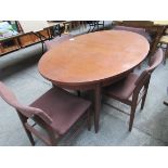 Hardwood extending oval table with four Scandart Ltd chairs.
