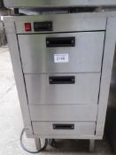 Three drawer stainless steel hot cupboard. Estimate £150-175.