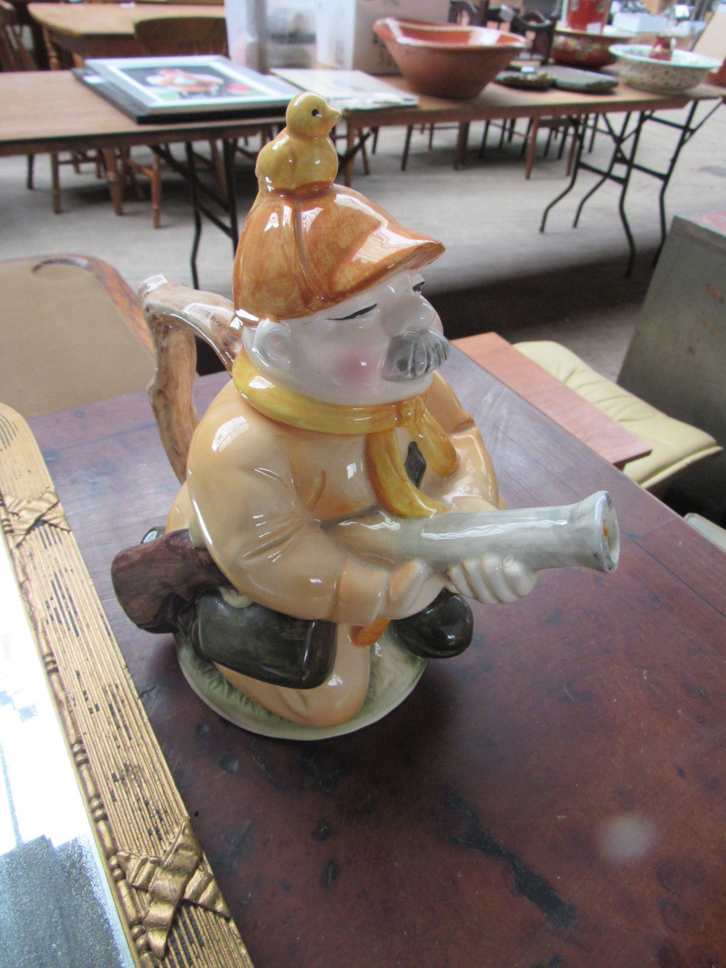 Gilt framed mirror and novelty tea pot.