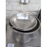 4 Stainless steel colanders. Estimate £15-20.