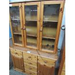 Pine glass top display cabinet with cupboard and drawers to base, 115 x 43 x 180cms.