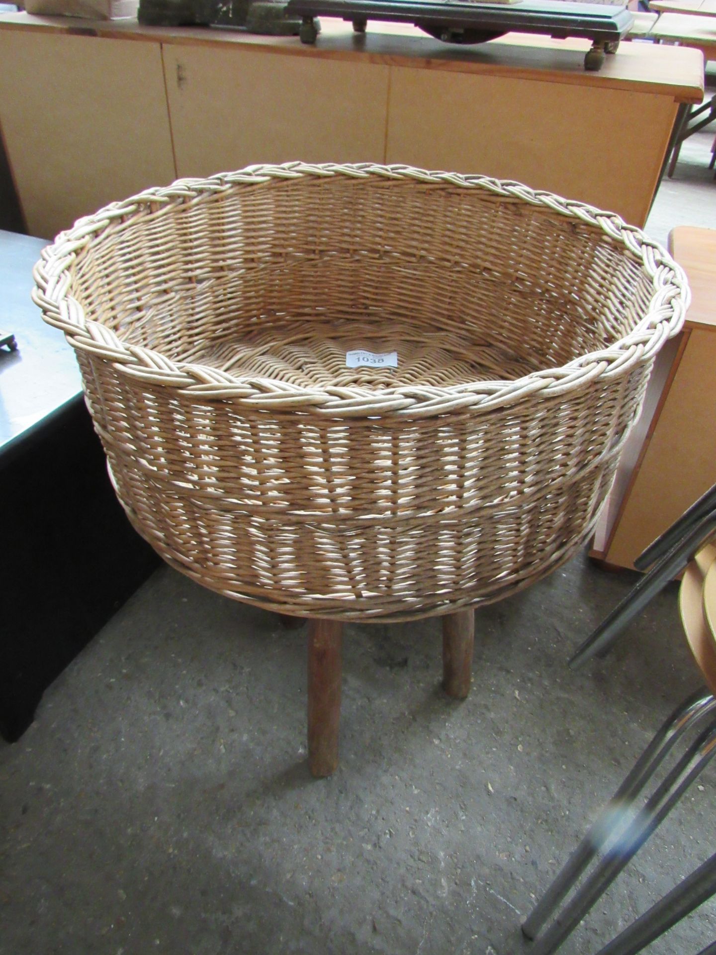 Wicker basket on stand, diameter 56cms, height 73cms.